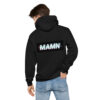 A man wearing a black hoodie with the word mamn on it.